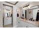 Double vanity bathroom with granite countertop and modern fixtures at 324 Wexford Ter # 171, Venice, FL 34293