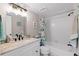 Bathroom with white vanity, tiled shower and tub at 324 Wexford Ter # 171, Venice, FL 34293