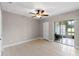 Bedroom with tiled floors, ceiling fan, and access to patio at 324 Wexford Ter # 171, Venice, FL 34293