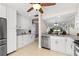 Spacious kitchen with white cabinets, stainless steel appliances and open to dining area at 324 Wexford Ter # 171, Venice, FL 34293