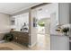 Kitchen with white cabinets, wood island, and access to a patio at 324 Wexford Ter # 171, Venice, FL 34293