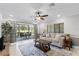 Living room with tiled floors, couch, and view of patio at 324 Wexford Ter # 171, Venice, FL 34293