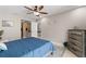 Main bedroom with dresser, ceiling fan and access to bathroom at 324 Wexford Ter # 171, Venice, FL 34293