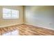 Bright bedroom with wood flooring and large window at 3730 Cadbury Cir # 400, Venice, FL 34293