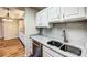 Bright kitchen featuring white cabinets and granite countertops at 3730 Cadbury Cir # 400, Venice, FL 34293