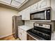Modern kitchen with stainless steel appliances and granite countertops at 3730 Cadbury Cir # 400, Venice, FL 34293
