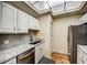 Updated kitchen with white cabinets, granite counters and stainless steel appliances at 3730 Cadbury Cir # 400, Venice, FL 34293