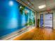 Lobby with beach mural, wood floors, and access to exterior at 3730 Cadbury Cir # 400, Venice, FL 34293