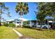 Single-story home with carport and lush landscaping at 421 Wexford Cir # 71, Venice, FL 34293