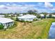 Aerial view of house with a screened porch and backyard near a lake at 452 Wexford Cir # 105, Venice, FL 34293