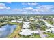 Aerial view of a residential community with a lake and lush greenery at 452 Wexford Cir # 105, Venice, FL 34293