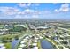 Aerial view of community with lush landscaping and waterways at 452 Wexford Cir # 105, Venice, FL 34293