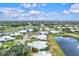 Aerial view of community with houses surrounding a lake at 452 Wexford Cir # 105, Venice, FL 34293
