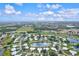 Aerial view of community with golf course, lake, and numerous homes at 452 Wexford Cir # 105, Venice, FL 34293