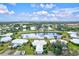 Aerial view of a community with houses, lake, and lush green landscape at 452 Wexford Cir # 105, Venice, FL 34293