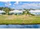 Aerial view of home's back, featuring a screened porch and a lake view at 452 Wexford Cir # 105, Venice, FL 34293