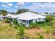 Aerial view of a home's back, showcasing a screened patio and garden at 452 Wexford Cir # 105, Venice, FL 34293