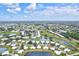 Aerial view of community featuring a lake and golf course at 452 Wexford Cir # 105, Venice, FL 34293