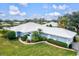 Aerial view of a single-story home with white roof and landscaped yard at 452 Wexford Cir # 105, Venice, FL 34293