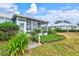 Backyard with patio and lush landscaping at 452 Wexford Cir # 105, Venice, FL 34293