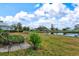 Landscaped backyard with pond view and patio at 452 Wexford Cir # 105, Venice, FL 34293