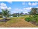 Backyard with pond view and lush landscaping at 452 Wexford Cir # 105, Venice, FL 34293