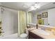 Clean bathroom with tub shower, updated vanity, and mirror at 452 Wexford Cir # 105, Venice, FL 34293