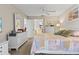 Main bedroom with king bed, dresser, and access to bathroom at 452 Wexford Cir # 105, Venice, FL 34293