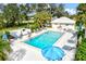 Community pool with lounge chairs and umbrellas at 452 Wexford Cir # 105, Venice, FL 34293