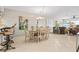 Bright dining area with seating for six and a view into the living room at 452 Wexford Cir # 105, Venice, FL 34293