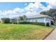 Single story home with 2-car garage and landscaped lawn at 452 Wexford Cir # 105, Venice, FL 34293