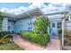 Side view of house showing entrance, landscaping, and patio furniture at 452 Wexford Cir # 105, Venice, FL 34293