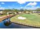 Golf course with water features and homes nearby at 452 Wexford Cir # 105, Venice, FL 34293