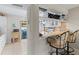 Kitchen with breakfast bar, wine rack, and white cabinetry at 452 Wexford Cir # 105, Venice, FL 34293