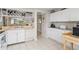Modern kitchen featuring white cabinets, granite countertops, and updated appliances at 452 Wexford Cir # 105, Venice, FL 34293