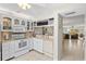 Bright kitchen features white cabinets, updated appliances, and a breakfast bar at 452 Wexford Cir # 105, Venice, FL 34293
