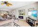 Living room with TV, fireplace, and comfortable seating at 452 Wexford Cir # 105, Venice, FL 34293