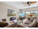 Living area featuring a fireplace, large TV, and sliding doors to patio at 452 Wexford Cir # 105, Venice, FL 34293