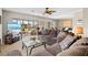 Spacious living room with comfortable seating, large TV, and access to balcony at 452 Wexford Cir # 105, Venice, FL 34293