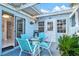 Private patio with string lights, glass table, and comfortable seating at 452 Wexford Cir # 105, Venice, FL 34293