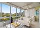 Spacious sunroom showcasing a tranquil lake view and comfortable furniture at 452 Wexford Cir # 105, Venice, FL 34293