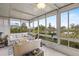 Bright sunroom overlooking a peaceful lake view, complete with comfy seating at 452 Wexford Cir # 105, Venice, FL 34293