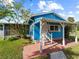 Front view of a blue house with covered porch and yard at 4533 Church St, Punta Gorda, FL 33980