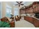 Home office with custom built-ins, desk space, and comfortable seating area at 457 Anchorage Dr, Nokomis, FL 34275