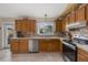 Kitchen boasts wood cabinets, granite countertops and stainless steel appliances at 508 Foxwood Blvd, Englewood, FL 34223