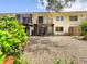 Backyard view of property, gravel and tropical plants at 509 Parkdale Mews # 509, Venice, FL 34285