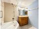 Bathroom with tub, shower, vanity with wood cabinet at 509 Parkdale Mews # 509, Venice, FL 34285