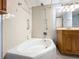 Clean bathroom with tub, shower, and wood vanity at 509 Parkdale Mews # 509, Venice, FL 34285