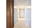 Hallway with tile floors and built-in storage at 509 Parkdale Mews # 509, Venice, FL 34285