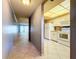 Condo kitchen with white appliances and tile floor at 509 Parkdale Mews # 509, Venice, FL 34285